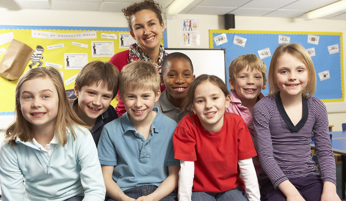 Schoolchildren In classroom with teacher